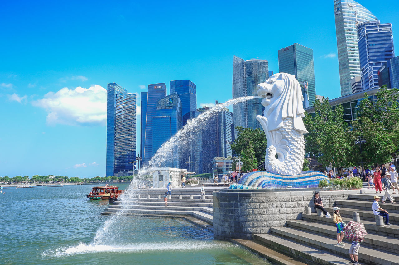 Singapore - JULY 11 2019: Merlion the signature of Singapore at the merlion park in Holidays with city building and blue sky background  